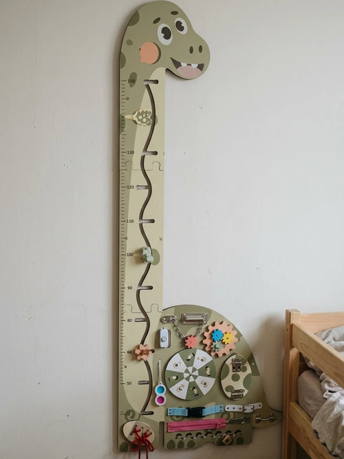 Wooden dinosaur growth chart on a bedroom wall