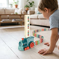 Domino train that lays the dominoes, being played with at home