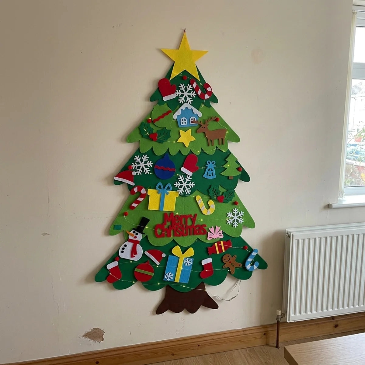 Felt Christmas tree hung on a wall, fully decorated