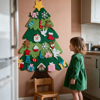 Felt Christmas tree wall hanging next to a toddler for scale