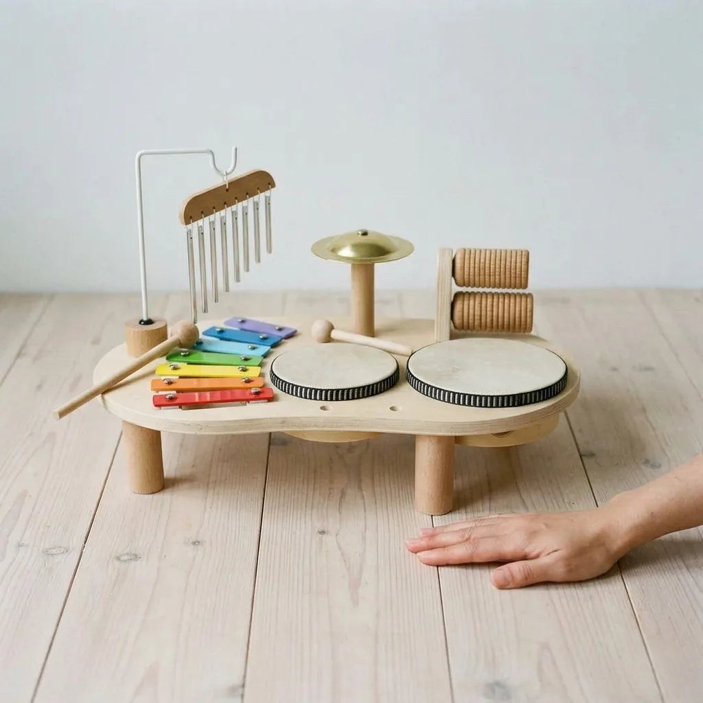 Montessori wooden music set for toddlers held in an adult hand for scale
