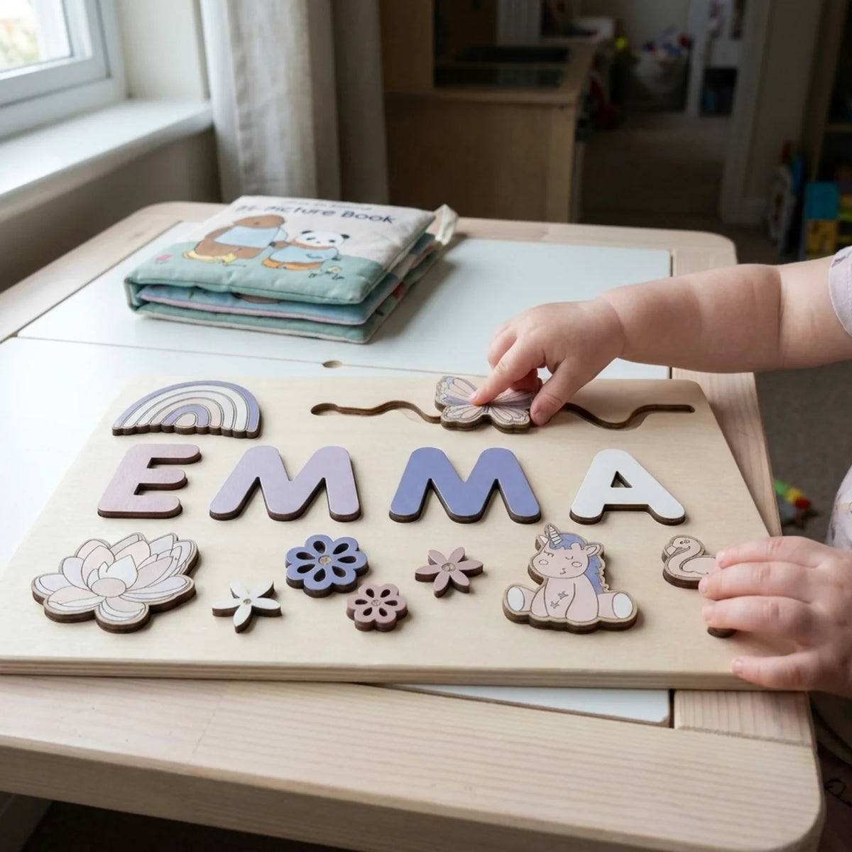Enchanted name puzzle, child sliding the butterfly piece
