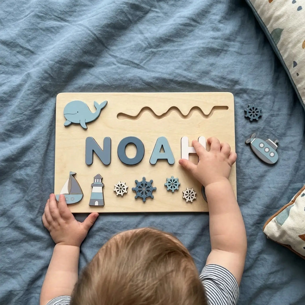 Ocean name puzzle, toddler pressing a letter into place