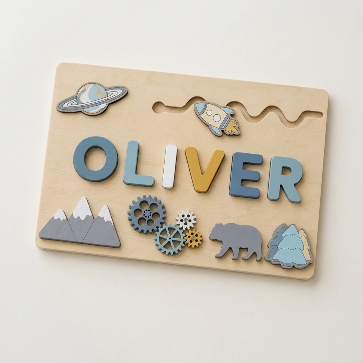Wooden name puzzle board with rocket and mountain pieces