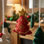 Close-up of the hand-stitched wool felt on the Santa & Trees crib mobile