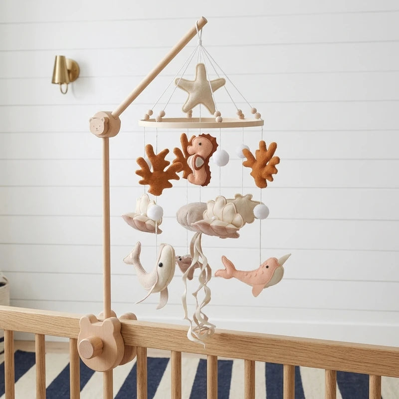 Wooden baby crib mobile, Terracotta Coral design, clamped on a crib rail in a ocean nursery