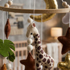 Close-up of the hand-stitched wool felt on the Golden Moon Safari crib mobile