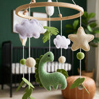Close-up of the hand-stitched wool felt on the Green Dinosaur crib mobile