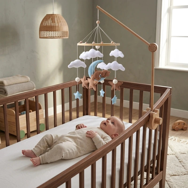 Baby lying in the crib looking up at the Blue Moon Bear felt mobile