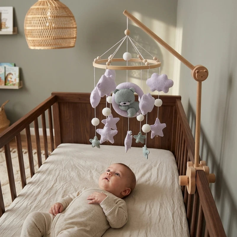 Baby lying in the crib looking up at the Lilac Moon Bear felt mobile