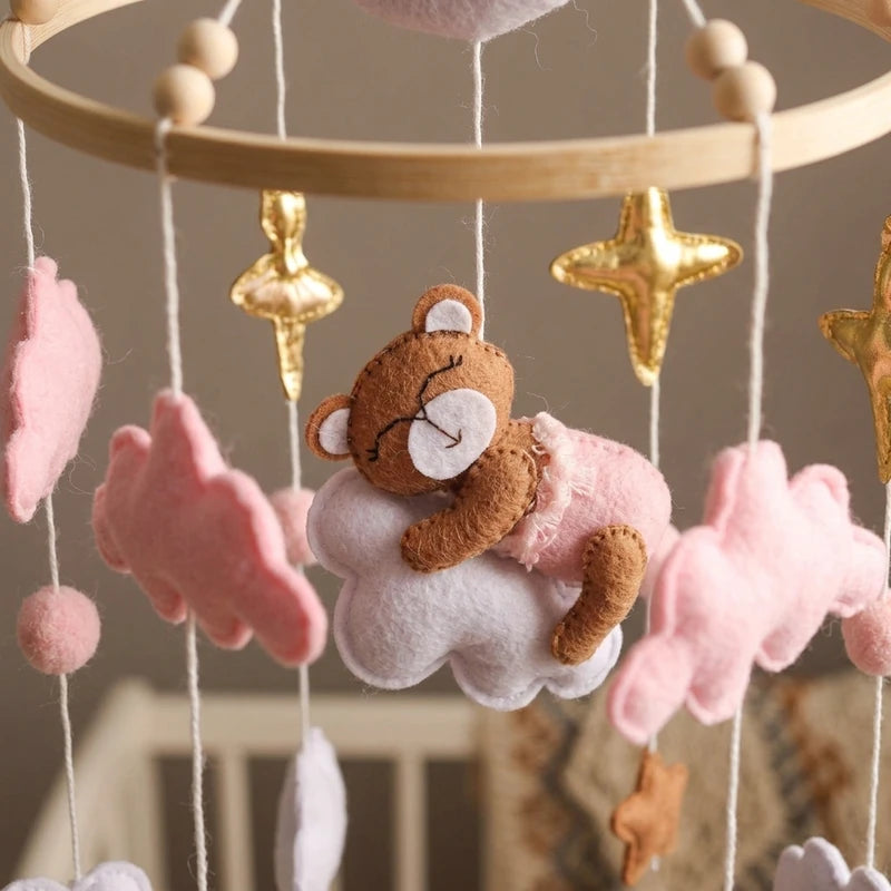 Close-up of the hand-stitched wool felt on the Pink Cloud Bear crib mobile