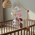 Wooden baby crib mobile, Pink Cloud Bear design, clamped on a crib rail in a sky nursery