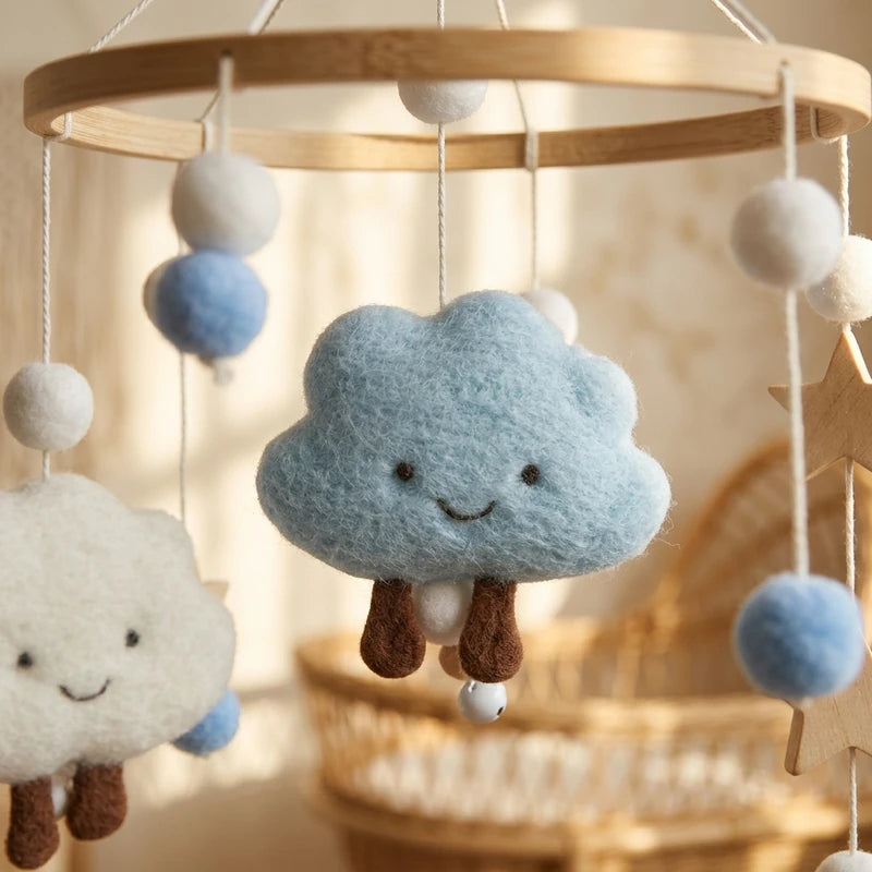 Close-up of the hand-stitched wool felt on the Smiling Clouds crib mobile