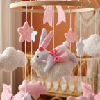 Close-up of the hand-stitched wool felt on the Pink Bunny & Clouds crib mobile