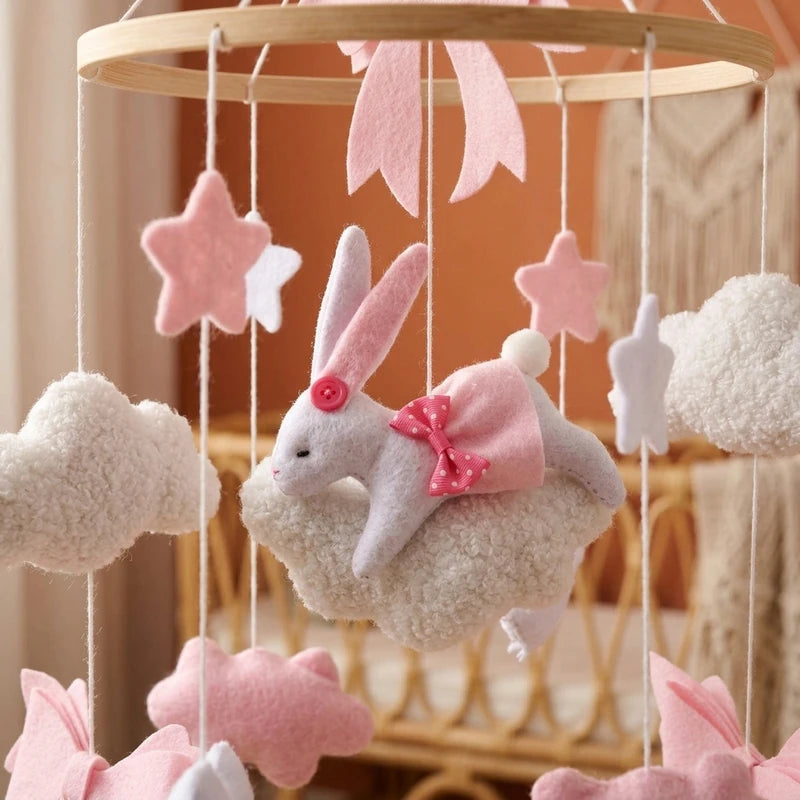 Close-up of the hand-stitched wool felt on the Pink Bunny & Clouds crib mobile