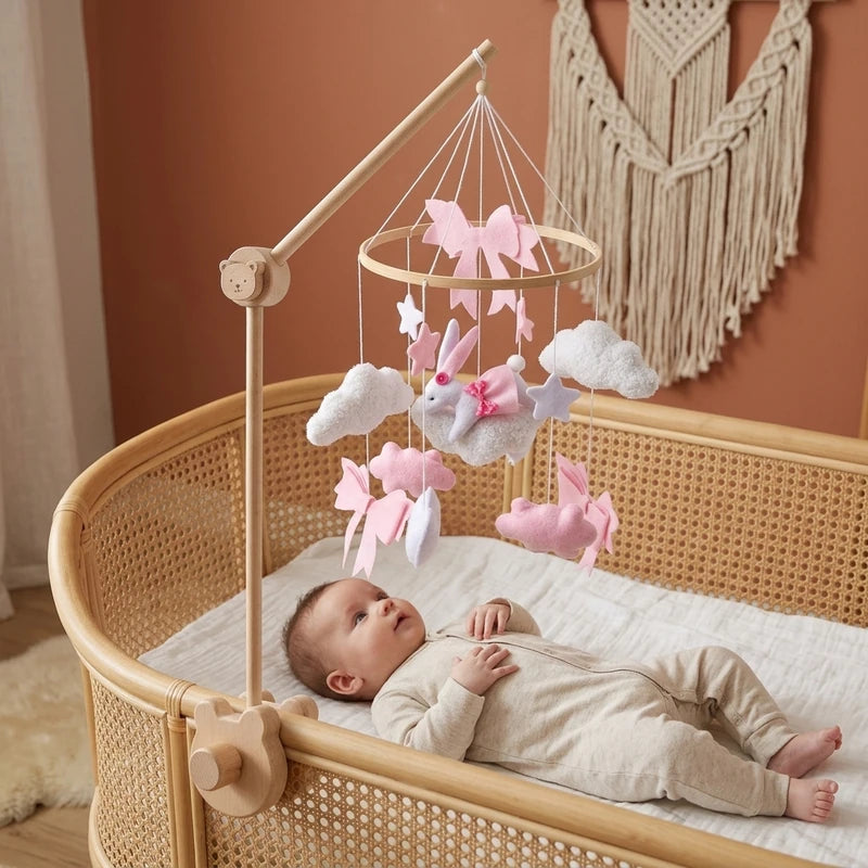 Baby lying in the crib looking up at the Pink Bunny & Clouds felt mobile