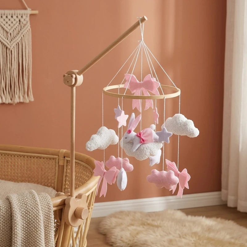 Wooden baby crib mobile, Pink Bunny & Clouds design, clamped on a crib rail in a woodland nursery